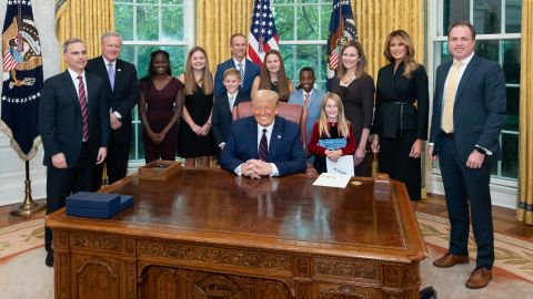 President Donald Trump is joined by a few members of his staff, the first lady, Amy Coney Barrett and Barrett's family during a Oval Office photo op on Saturday, September 26. Barrett is third from right, next to Melania Trump. Her husband, Jesse, is in the back center. At left is White House Counsel Pat Cipollone, next to White House Chief of Staff Mark Meadows.