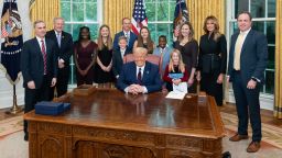 President Donald J. Trump and First Lady Melania Trump, joined by White House senior advisors, pose for a photo with Judge Amy Coney Barrett, the President's nominee for Associate Justice of the Supreme Court of the United States, her husband Jesse and their children Saturday, Sept. 26, 2020, in the Oval Office of the White House. (Official White House Photo by Andrea Hanks)