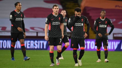 Mo Salah (right) and James Milner look on in Liverpool's thrashing by Aston Villa. 