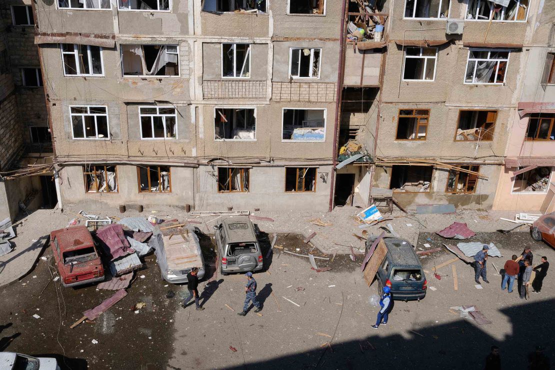 People walk in a residential area of Stepanakert that was allegedly damaged by shelling.