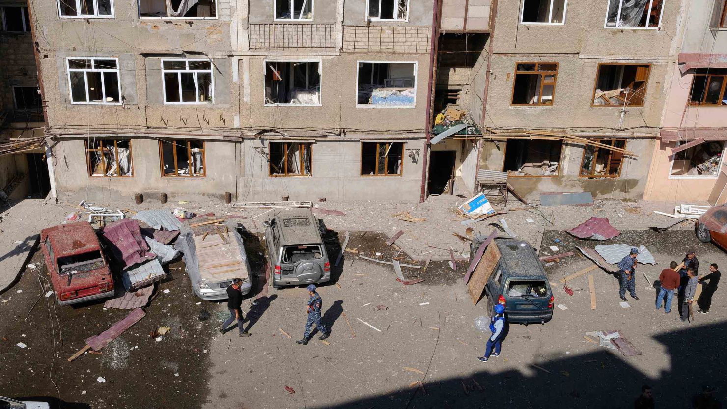 People walk in a residential area of Stepanakert that was allegedly damaged by shelling on Saturday.
