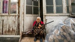 Old woman stands in the entrance of her home with a rifle during the shelling of the azeri army over Stepanakert city during the clashes between Azerbaijan and Nagorno Karabakh. The old woman is determined not to move and defend her home until the last moments. (Photo by Celestino Arce/NurPhoto/Getty Images)