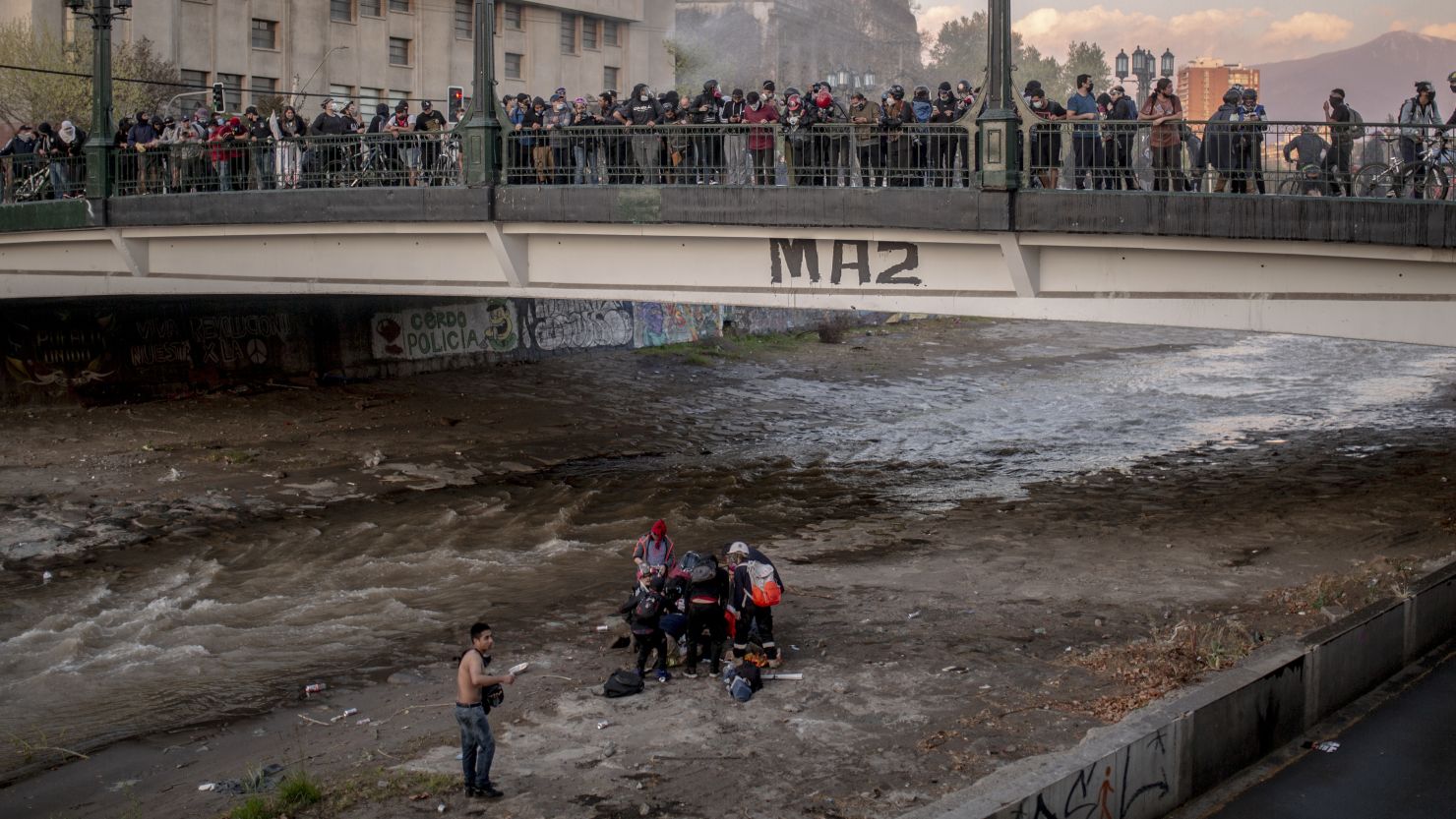 A 16-year-old boy is treated by rescue personnel in the Mapocho river after the incident.