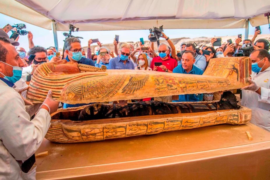 Multiple sarcophagi on display on October 3 at a press event. Fifty-nine wooden coffins were retrieved in good condition with original colors and markings. Egyptian Minister of Tourism and Antiquities Khaled Al-Anani (L), and Mustafa Waziri (R), secretary general of the Supreme Council of Antiquities, open a sarcophagus from the Saqqara necropolis.