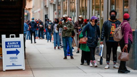 People wait in line to cast their ballots for the November 3 elections at the early voting Chicago Board of Elections' Loop Super Site in Chicago on Thursday, October 1. 
