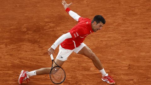 Djokovic plays a backhand against Khachanov as he progressed to the quarterfinals. 