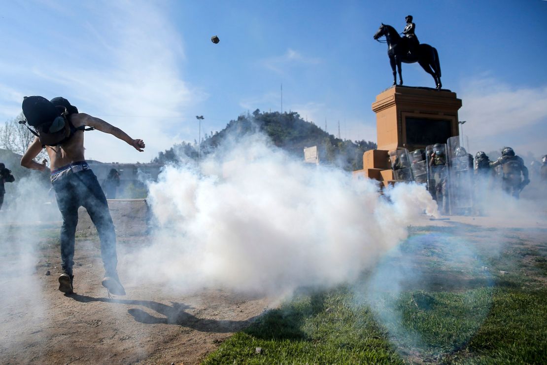 Demonstrators clash with riot police during a protest in Santiago on Saturday.