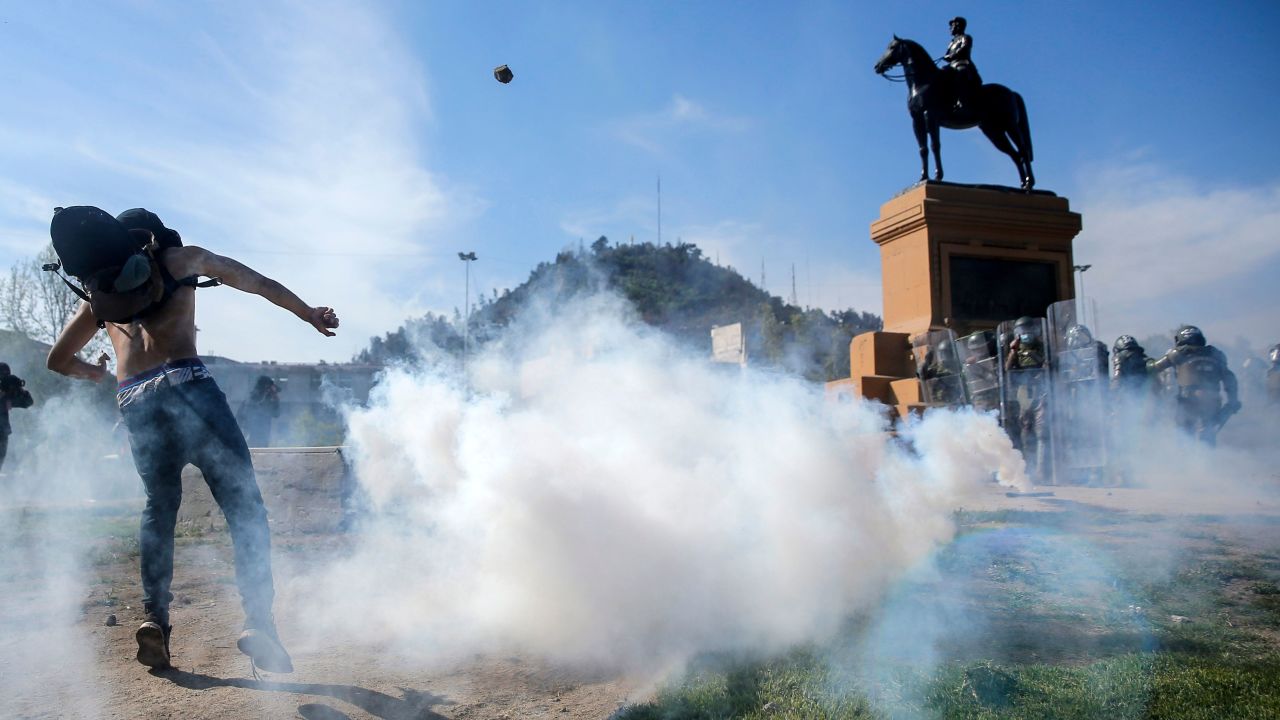 Demonstrators clash with riot police during a protest in Santiago on Saturday.
