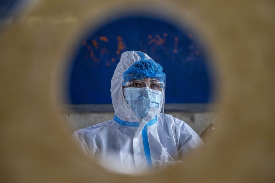 A health worker in Manila, Philippines, sits behind a booth October 6 during mass testing for public transportation drivers. 