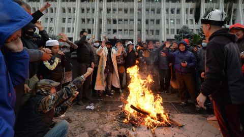 People protesting the results of an election gather Tuesday by a bonfire in front of the main government building, known as the White House, in Bishkek.