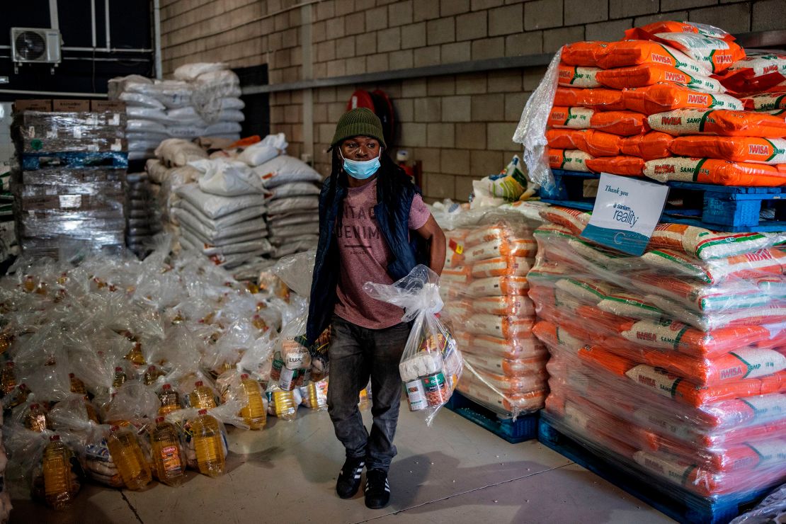 A volunteer loads food parcels marked for distribution at the Meals on Wheels Community Services South Africa in July. The poverty rate is expected to worsen this year, especially in "middle-income" countries such as South Africa.