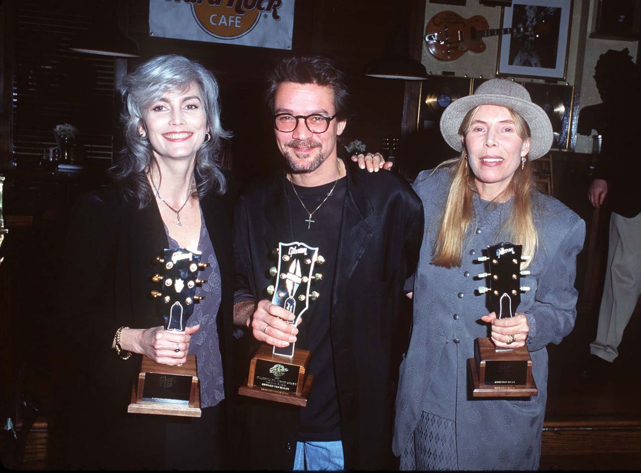 Emmylou Harris, Van Halen and Joni Mitchell pose with their trophies at the 1996 Gibson Guitar Awards at the Hard Rock Cafe in Los Angeles.