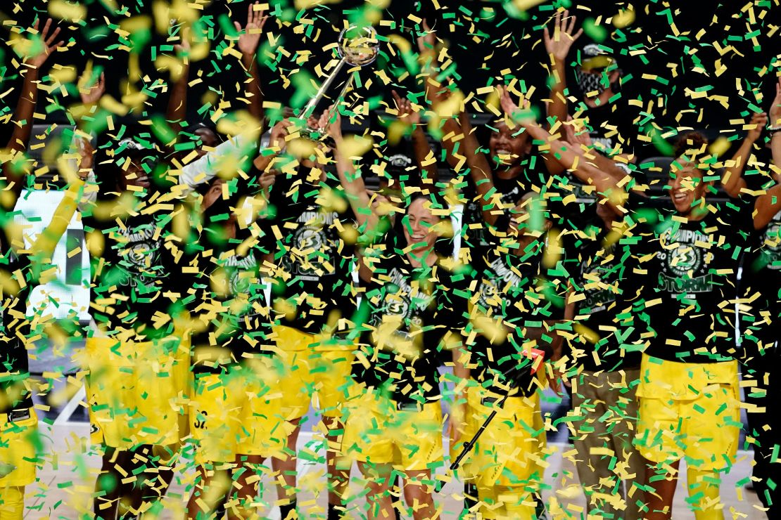 Seattle Storm guard Sue Bird holds up the trophy after the team defeated the Las Vegas Aces to win the WNBA Championship in Florida. 