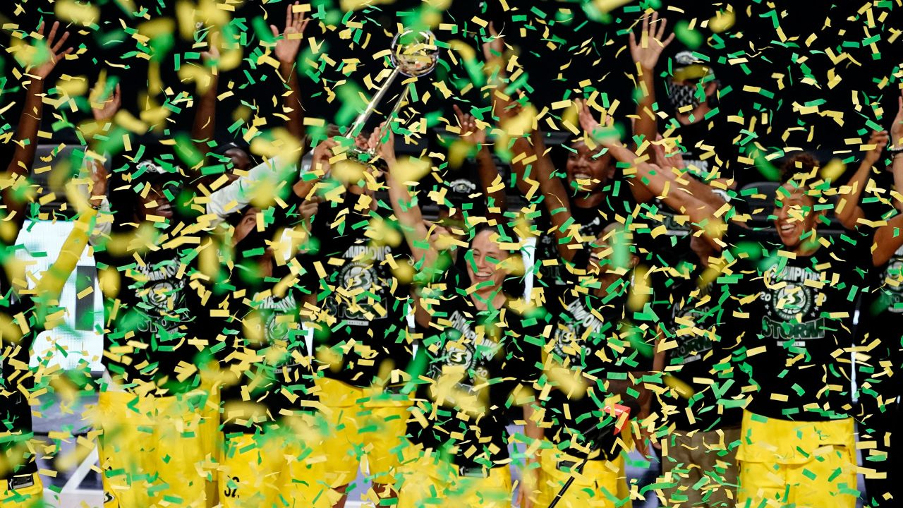 Seattle Storm guard Sue Bird holds up the trophy after the team defeated the Las Vegas Aces to win the WNBA Championship in Florida.