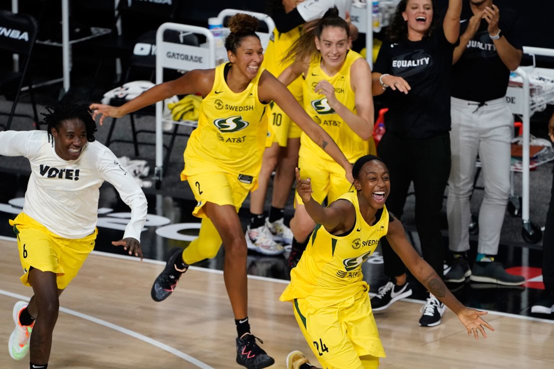 Members of the Seattle Storm rush the court after the team defeated the Las Vegas Aces to win the WNBA Championship in Bradenton, Florida, on Tuesday, October 6, 2020.