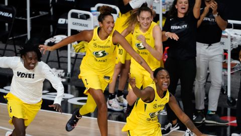 Members of the Seattle Storm rush the court after the team defeated the Las Vegas Aces to win the WNBA Championship in Bradenton, Florida, on Tuesday, October 6, 2020.