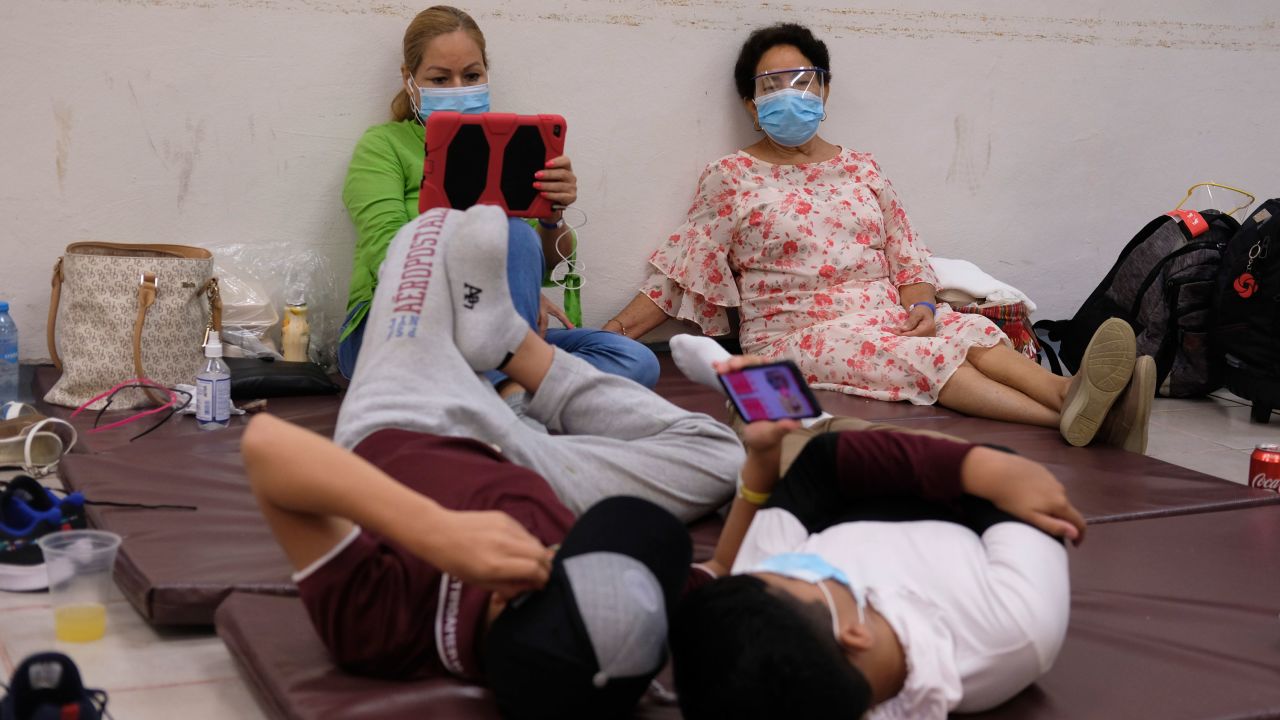 Tourists rest in a shelter at the Technological Institute of Cancun, Mexico.