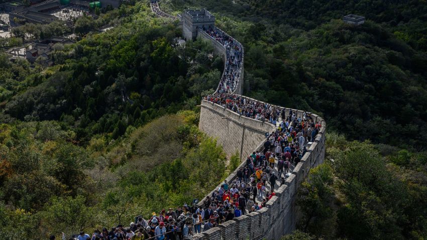 BEIJING, CHINA - OCTOBER 04: Chinese tourists walk on a crowded section of the Great Wall at Badaling after tickets sold out during the 'Golden Week' holiday on October 4, 2020  in Beijing, China. Officials are expecting the Golden Week holiday to boost China's consumer economy as people were encouraged to use the 8-day break to travel and spend. Tourist sites including the Great Wall were packed, with tickets selling out most days given pandemic restrictions and capacity capped at 75%.  (Photo by Kevin Frayer/Getty Images)