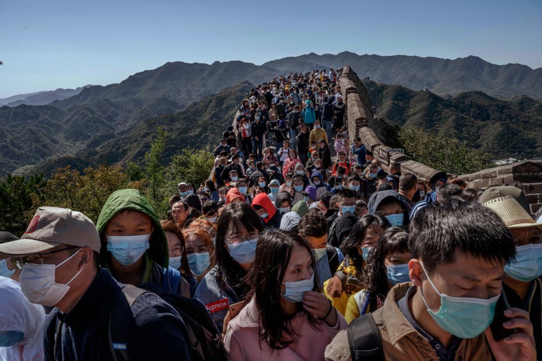 Chinese tourists crowd a bottleneck as they move slowly along the Great Wall of China during the Golden Week holiday in October, 2020.