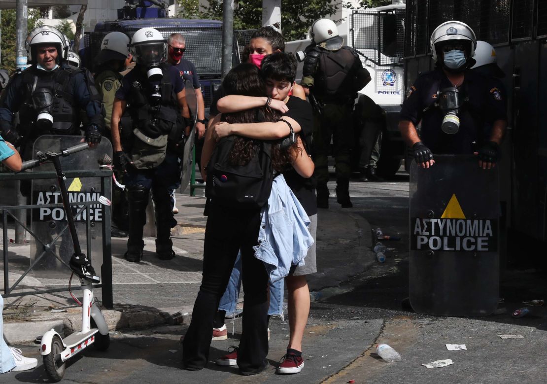 Protesters at the anti-fascist rally, embrace each other following the announcement of the verdict, outside the courthouse in Athens on Wednesday.