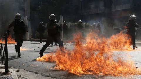 Riot policemen try to avoid flames from a petrol bomb thrown by protesters on Wednesday.