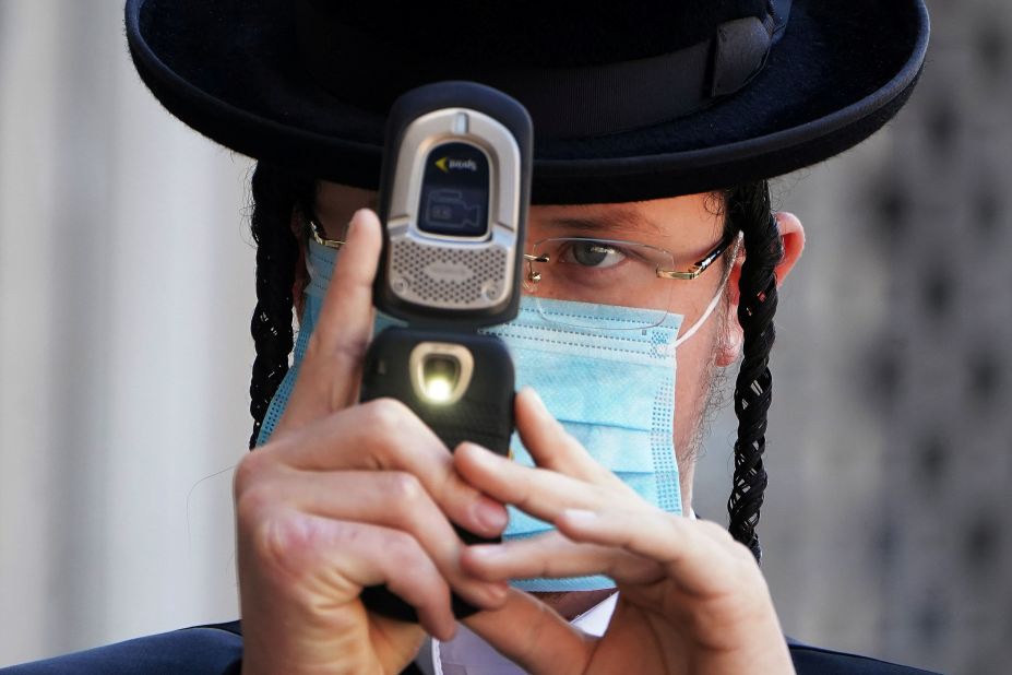 An Orthodox Jewish man takes photos of a photographer with his cell phone <a href="https://www.cnn.com/2020/10/07/us/new-york-protest-orthodox-jews/index.html" target="_blank">during protests in New York</a> on October 6. Members of the Orthodox Jewish community protested after the state announced new coronavirus-related restrictions.