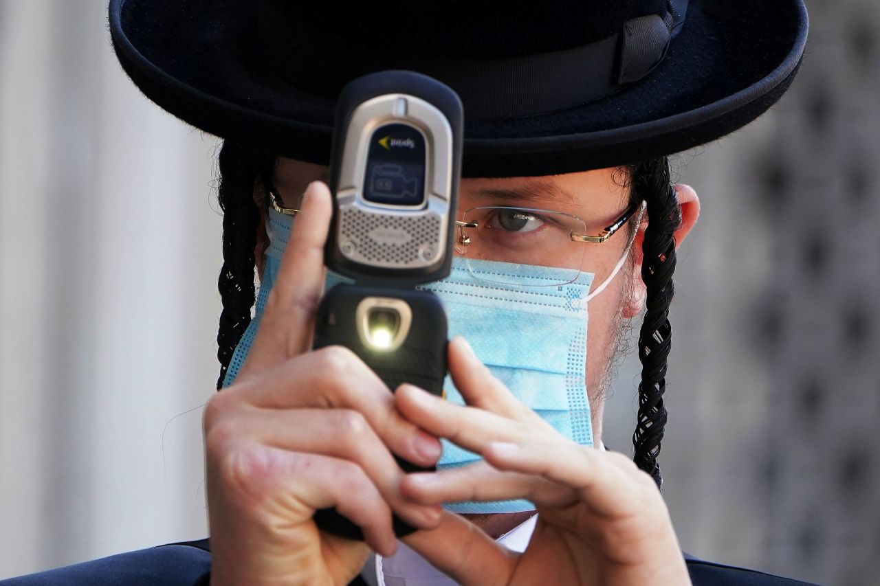 An Orthodox Jewish man takes photos of a photographer with his cell phone <a href="index.php?page=&url=https%3A%2F%2Fwww.cnn.com%2F2020%2F10%2F07%2Fus%2Fnew-york-protest-orthodox-jews%2Findex.html" target="_blank">during protests in New York</a> on October 6. Members of the Orthodox Jewish community protested after the state announced new coronavirus-related restrictions.