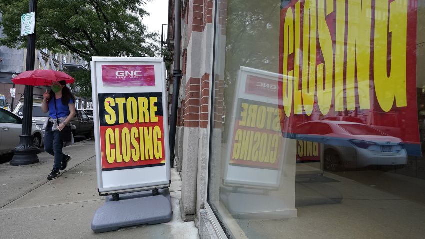 FILE - In this Sept. 2, 2020, file photo, a passerby walks past a business storefront with store closing signs in Boston. The U.S. unemployment rate dropped to 7.9% in September, but hiring is slowing and many Americans have given up looking for work, the government said Friday, Oct. 2, in the final jobs report before the voters decide whether to give President Donald Trump another term. (AP Photo/Steven Senne, File)
