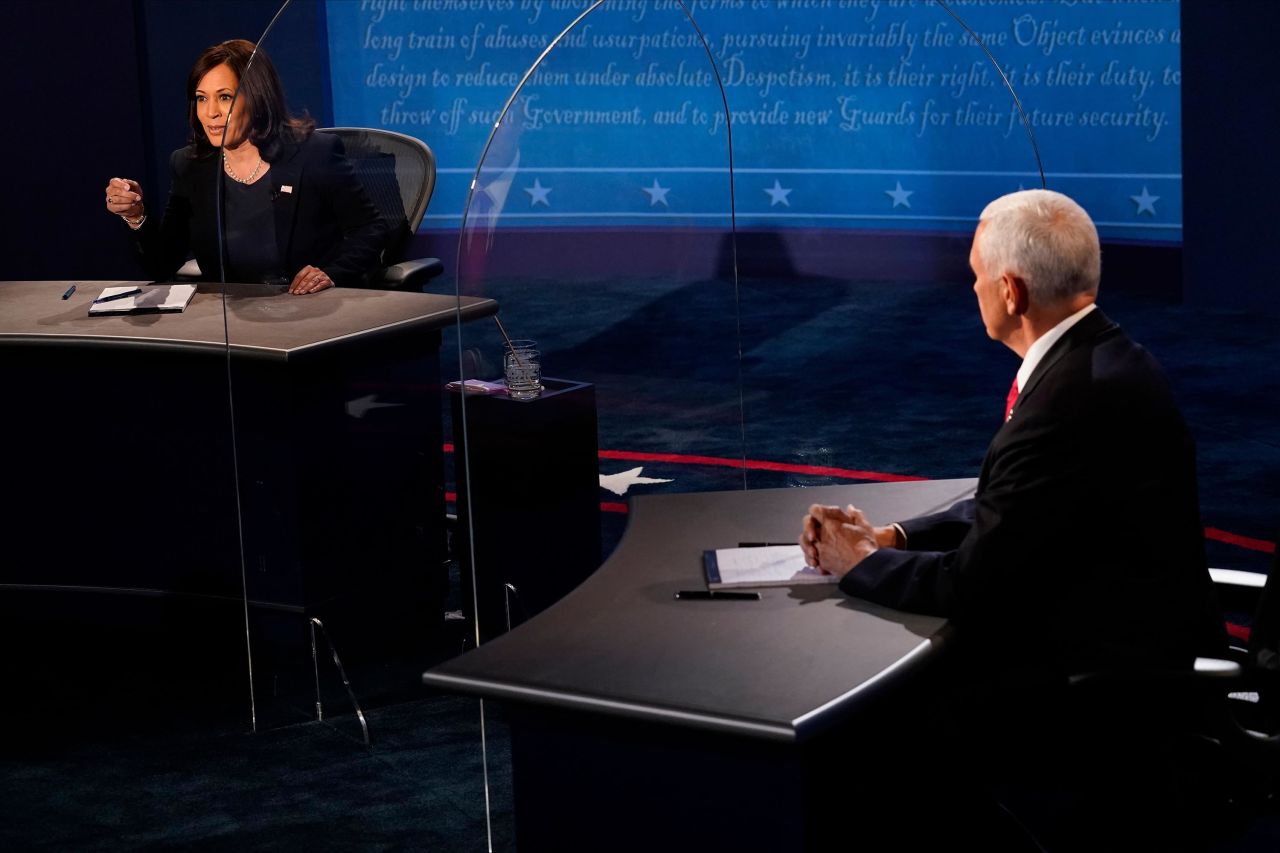 Pence listens to Harris during the debate.