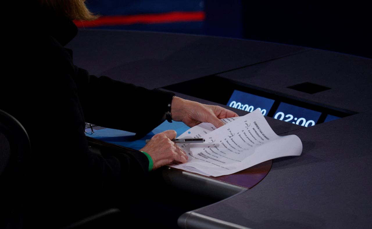 Page arranges her notes before the start of the debate.