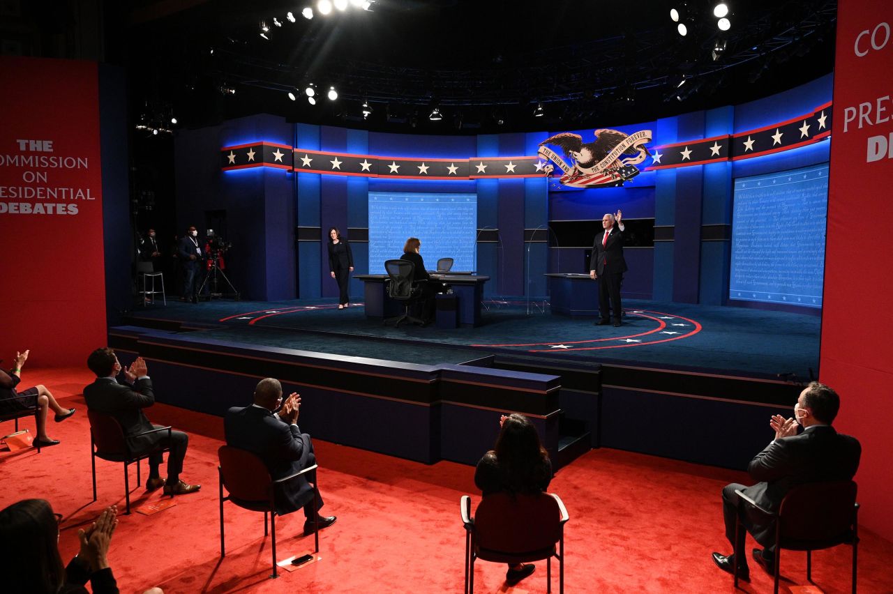 The candidates wave to the audience before the start of the debate.