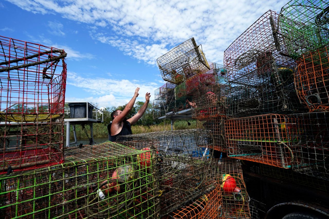 Brian Dufrene loads his crab traps on a trailer after pulling them from Bayou Dularge in anticipation of Hurricane Delta in Theriot, Louisiana, on October 7.