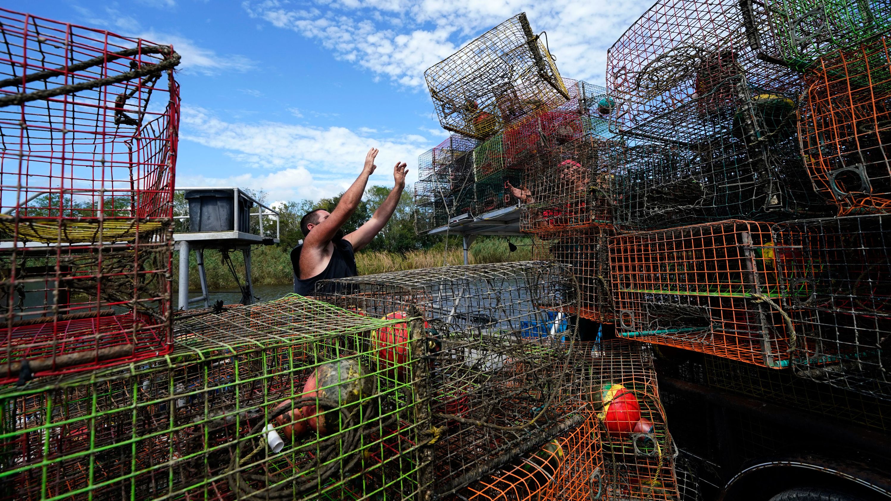Brian Dufrene loads his crab traps on a trailer after pulling them from Bayou Dularge in anticipation of Hurricane Delta in Theriot, Louisiana, on October 7.