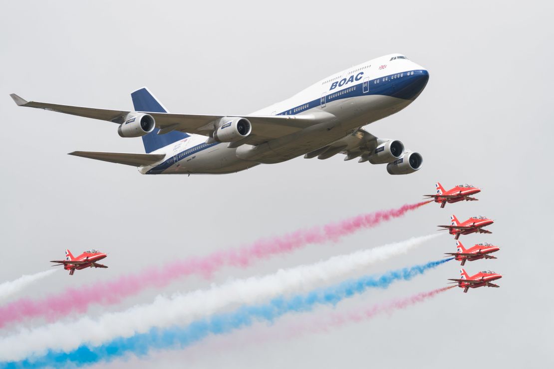 A special liveried Boeing 747 takes to the skies alongside the Red Arrows during the 2019 Royal International Air Tattoo on July 20, 2019.