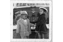 Sorin's father was an avid photographer and took this photo of his children in front of their car. 