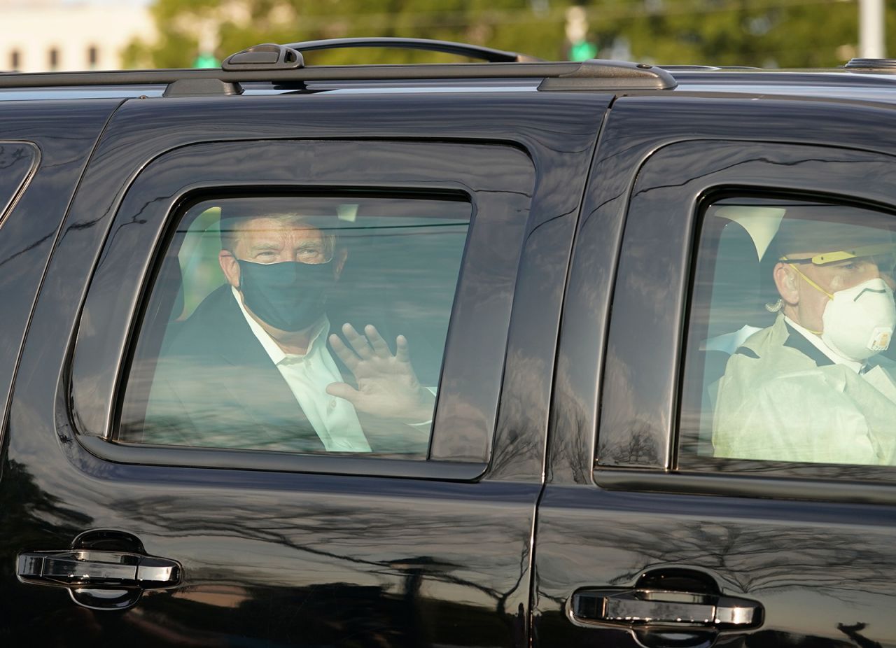 Trump briefly left the hospital to wave to his supporters from the back of an SUV. A Secret Service agent is seen in the front seat wearing a full medical gown, a respirator mask and a face shield.