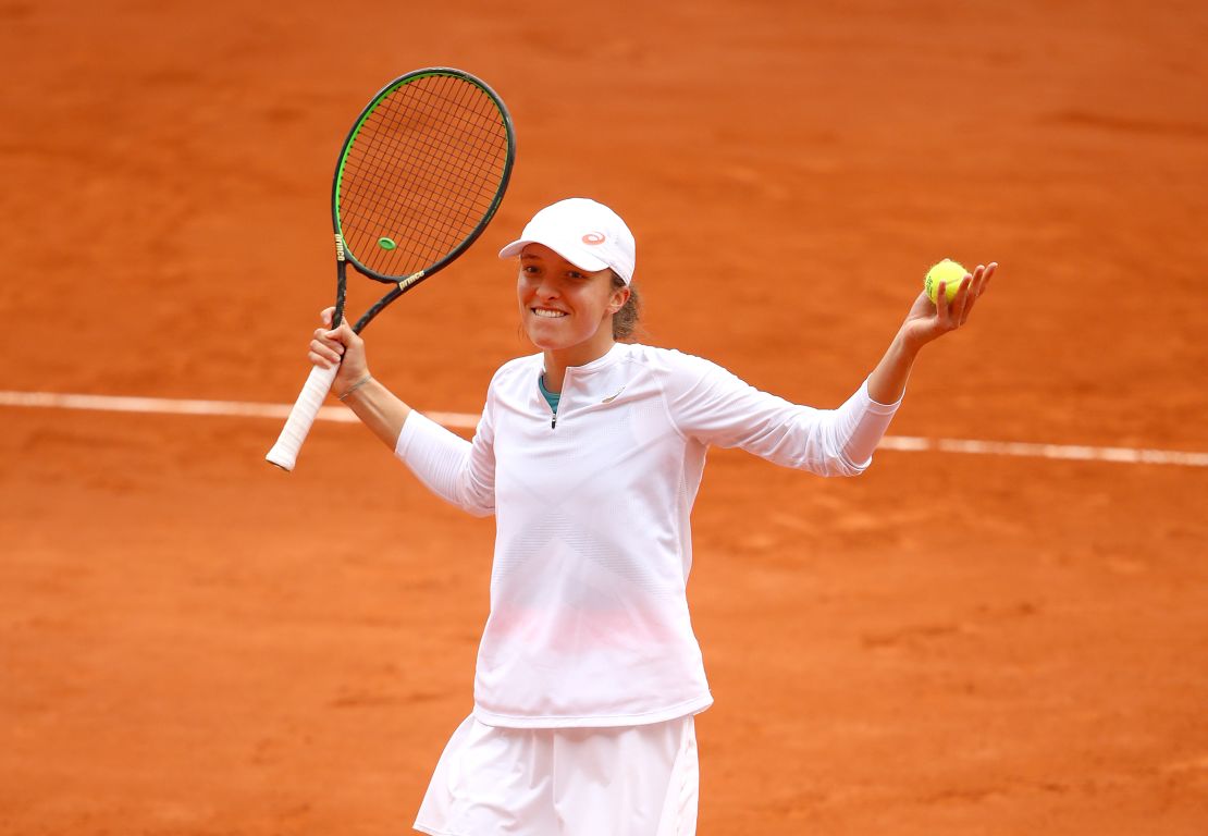 Swiatek reacts after winning match point in her French Open semifinal.
