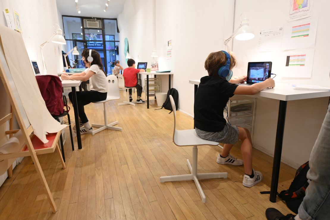 Millions of children are still learning exclusively online. Some attend "pods" as here in a shuttered art gallery in New York.