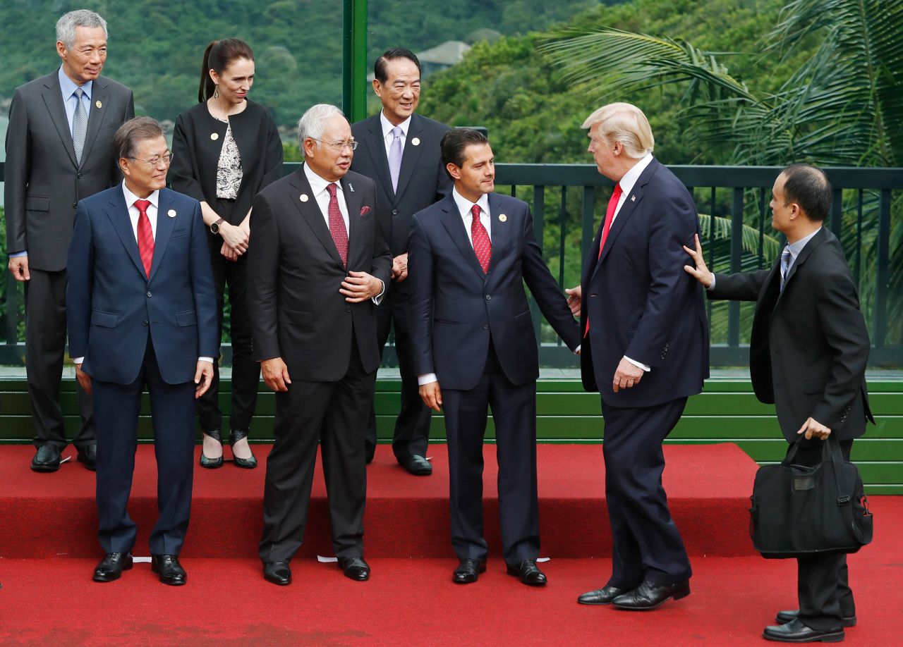 United States President Donald Trump joins South Korea's President Moon Jae-in, Malaysia's Prime Minister Najib Razak, Mexico's President Enrique Pena Nieto, Singapore's Prime Minister Lee Hsien Loong, New Zealand's Prime Minister Jacinda Ardern and Taiwan's representative James Soong to take part in a "family photo" during the Asia-Pacific Economic Cooperation (APEC) leaders' summit in the central Vietnamese city of Danang on November 11, 2017.