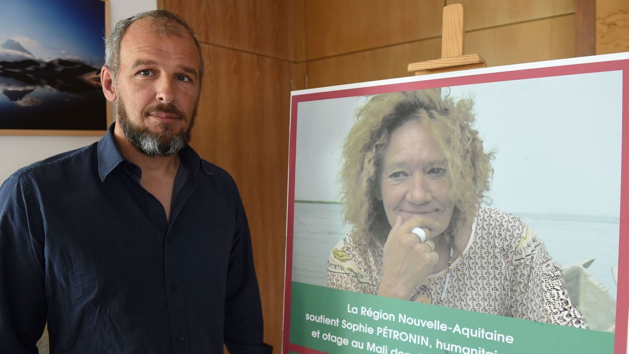 Sébastien Chadaud-Pétronin beside a photograph of his mother, Sophie Pétronin, in Bordeaux on August 29, 2018.