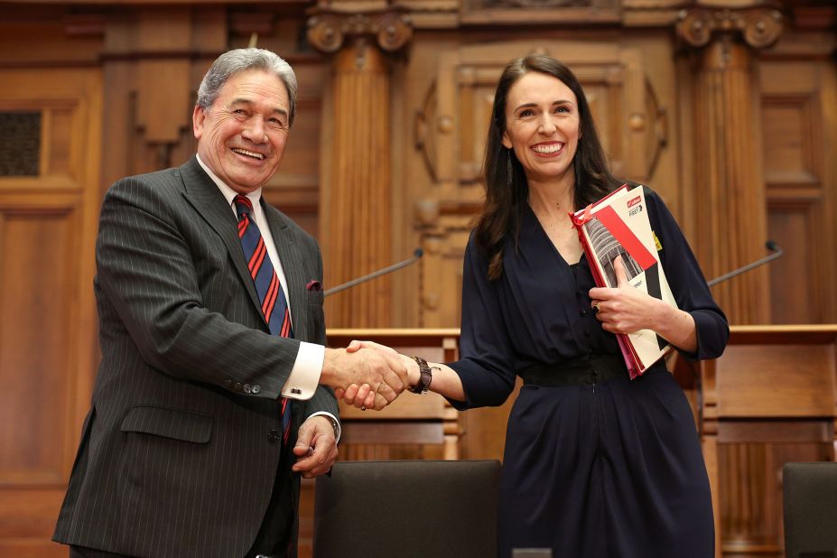 Prime Minister-designate Jacinda Ardern and New Zealand First leader Winston Peters shake hands during a coalition agreement signing at Parliament on October 24, 2017, in Wellington. For weeks after the country's 2017 general election, there was no clear victor, with neither major party winning an outright majority.