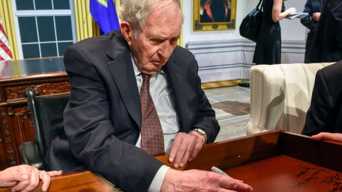 Lyon Gardiner Tyler Jr. signs his name on the inside of a desk drawer with other descendants of past presidents who gathered in Washington in August 2018.