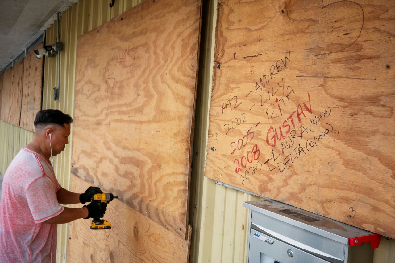 Bang Bui covers his business in plywood as Hurricane Delta approaches in Abbeville, Louisiana, on October 8.