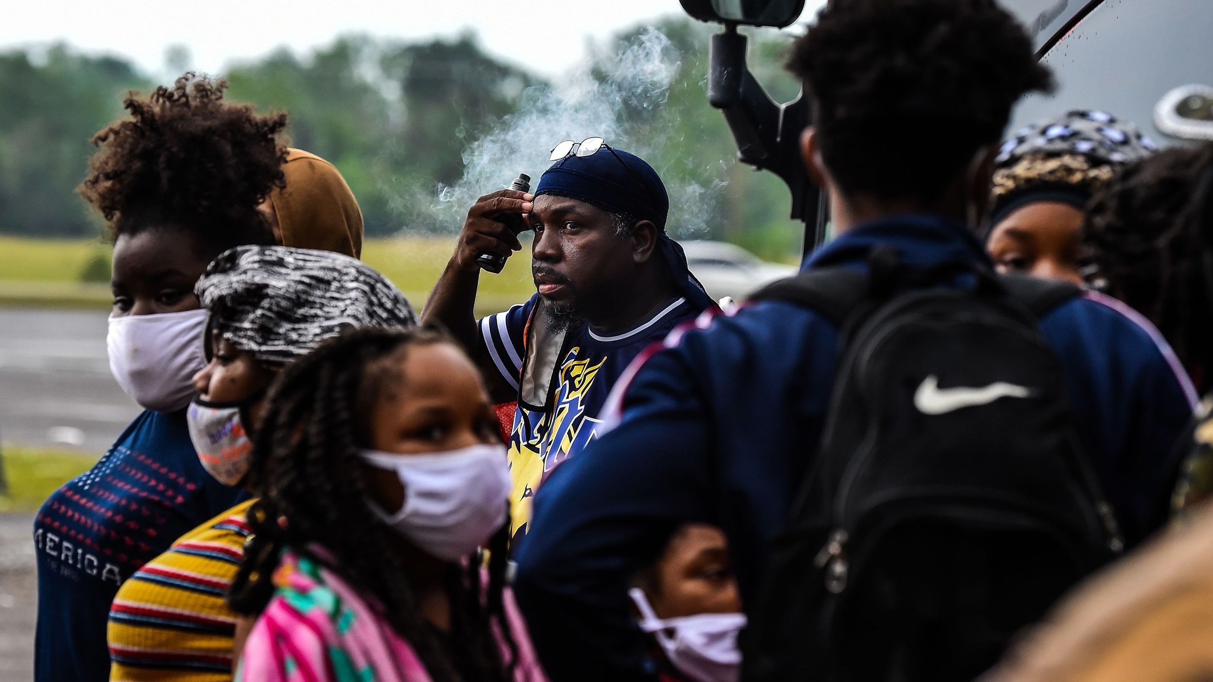 People line up to board a bus for evacuation before the arrival of hurricane Delta in Lake Charles, Louisiana, on Thursday, October 8.