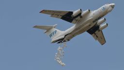 A Russian-made Ilyushin airlifter aircraft leased to the World Food Programme (WFP) makes a drop of food aid near a village in Ayod county, South Sudan, on February 6, 2020. - The villagers hear the distant roar of jet engines before a cargo plane makes a deafening pass over Mogok, dropping sacks of grain from its hold to the marooned dust bowl below. South Sudan is the last place on earth where food is airdropped, and in Mogok there was little other choice: without the tonnes of grains and cereals, people would have simply perished. (Photo by TONY KARUMBA / AFP) (Photo by TONY KARUMBA/AFP via Getty Images)