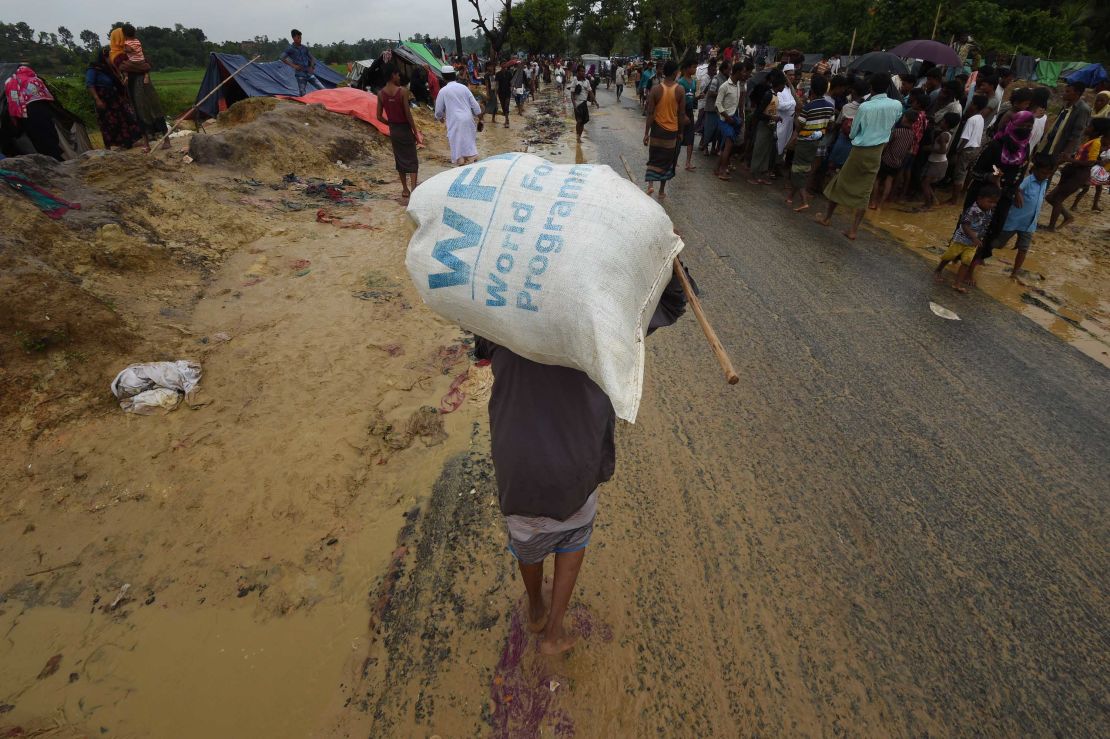 A Rohingya Muslim refugee carries a WFP rice bag along a road in Bangladesh in September 2017. 