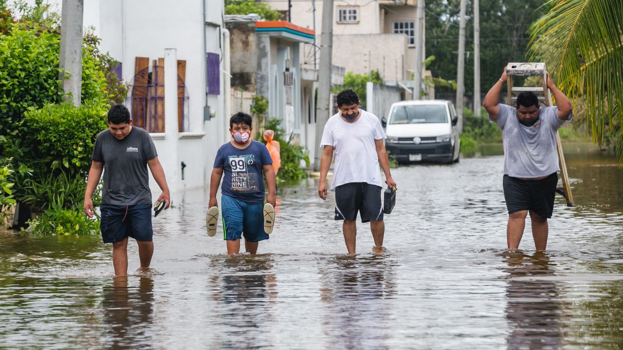 People walk on a flooded street after Hurricane Delta hit near Cozumel on October 07, 2020 in Cozumel, Mexico. 