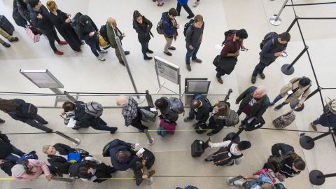Travelers stand in line to enter a Transportation Security Administration (TSA) checkpoint at San Francisco International Airport in San Francisco, California, U.S., on Wednesday, Nov. 27, 2019. The trade association Airlines for America has projected number of travelers will climb 3.7 percent from last year during the 12-day Thanksgiving travel period from Nov. 22 to Dec. 3. Photographer: David Paul Morris/Bloomberg via Getty Images