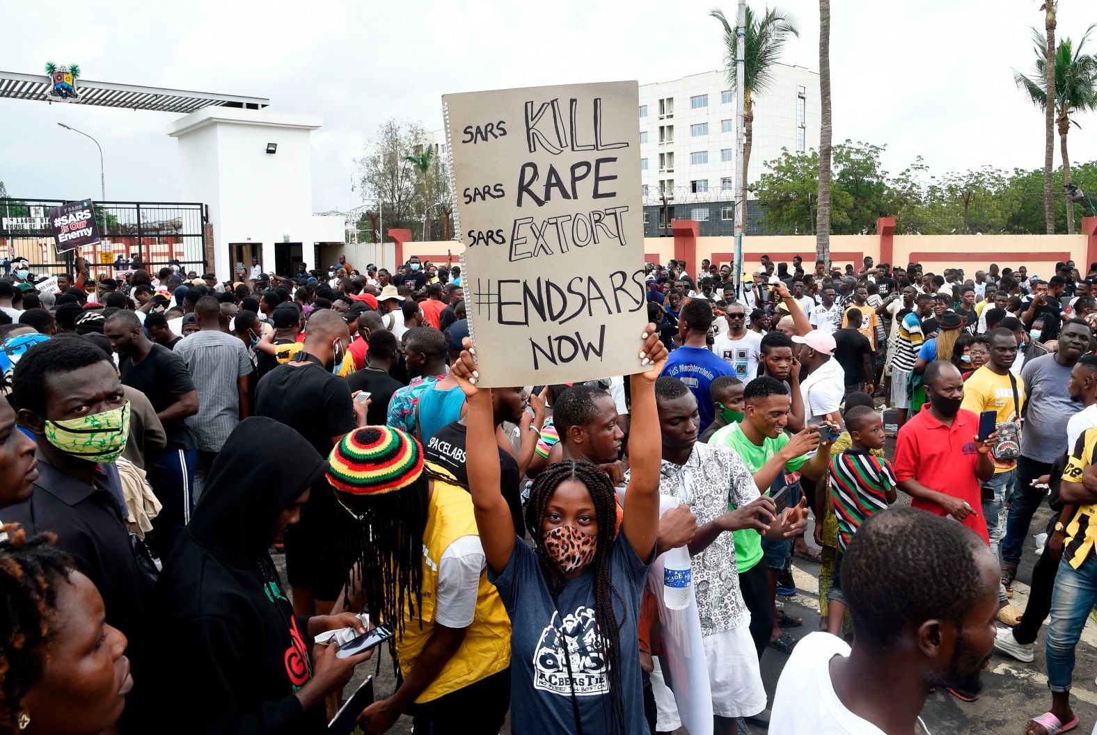 A protester holds up a sign near a government house in Ikeja on October 9.