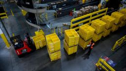 A man works at a distribution station at the 855,000-square-foot Amazon fulfillment center in Staten Island, one of the five boroughs of New York City, on February 5, 2019. - Inside a huge warehouse on Staten Island thousands of robots are busy distributing thousands of items sold by the giant of online sales, Amazon. (Photo by Johannes Eisele/AFP/Getty Images)
